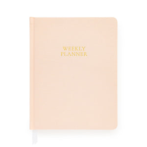 Pink planner with gold foil 'weekly planner' on cover