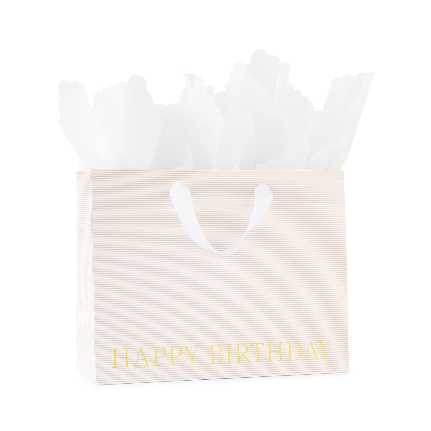 large gift bag with white ribbon handles with a pink stripe pattern printed with happy birthday in gold foil with white scallop tissue paper