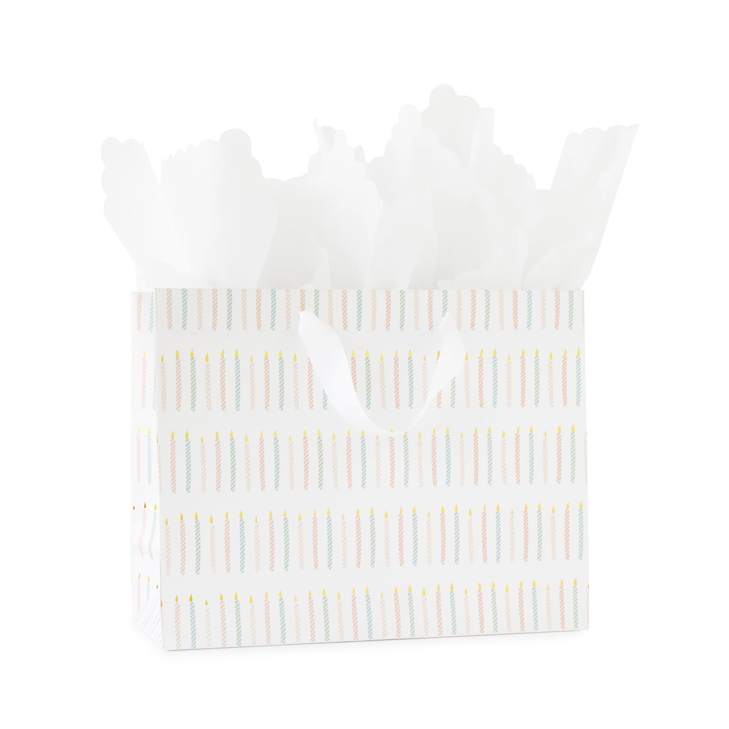 large gift bag with white ribbon handles printed with a colorful candle pattern in pink and blue with gold foil with white scallop tissue paper