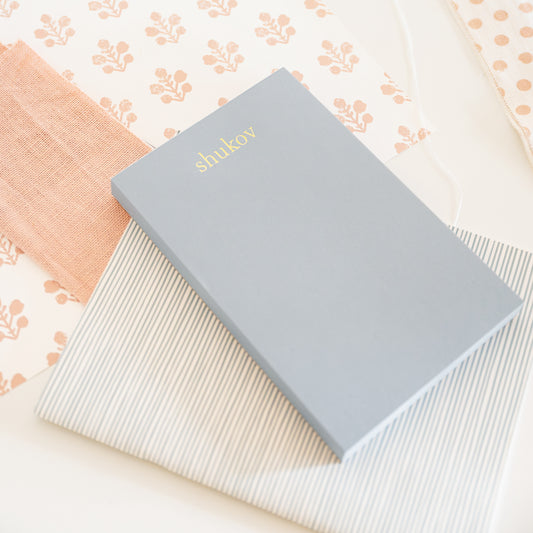 slate blue custom notepad on desk