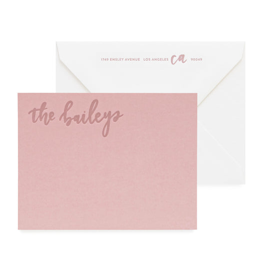 Dusty rose custom stationery note card printed with 'the baileys' in rose ink paired with a white envelope with rose ink return address