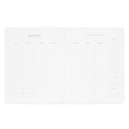 Interior of monthly planner with a monthly grid for August 2026, an inspirational quote, and notes on the side