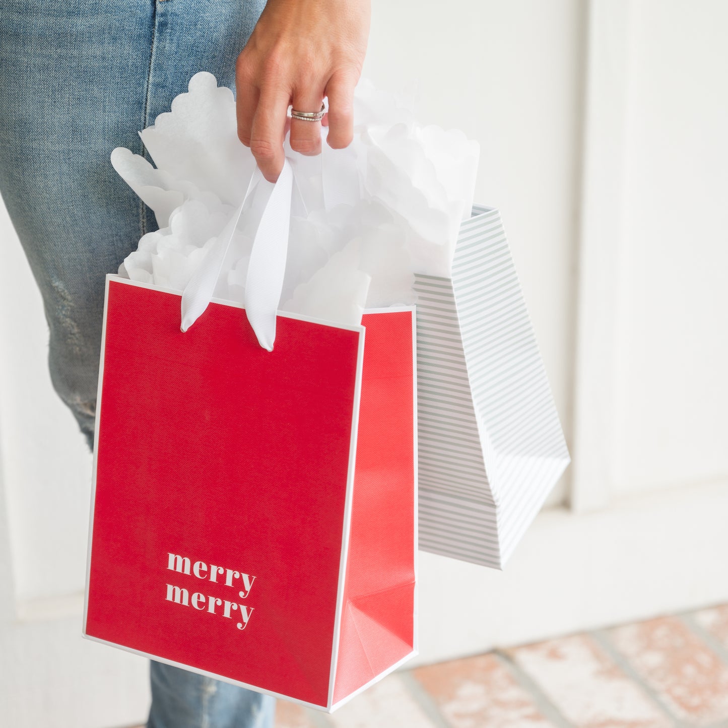 Holiday gift bags in hand