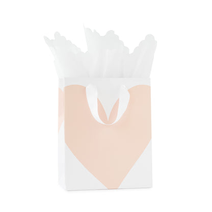 White gift bag with large pink heart and white ribbon handles with white scallop tissue paper