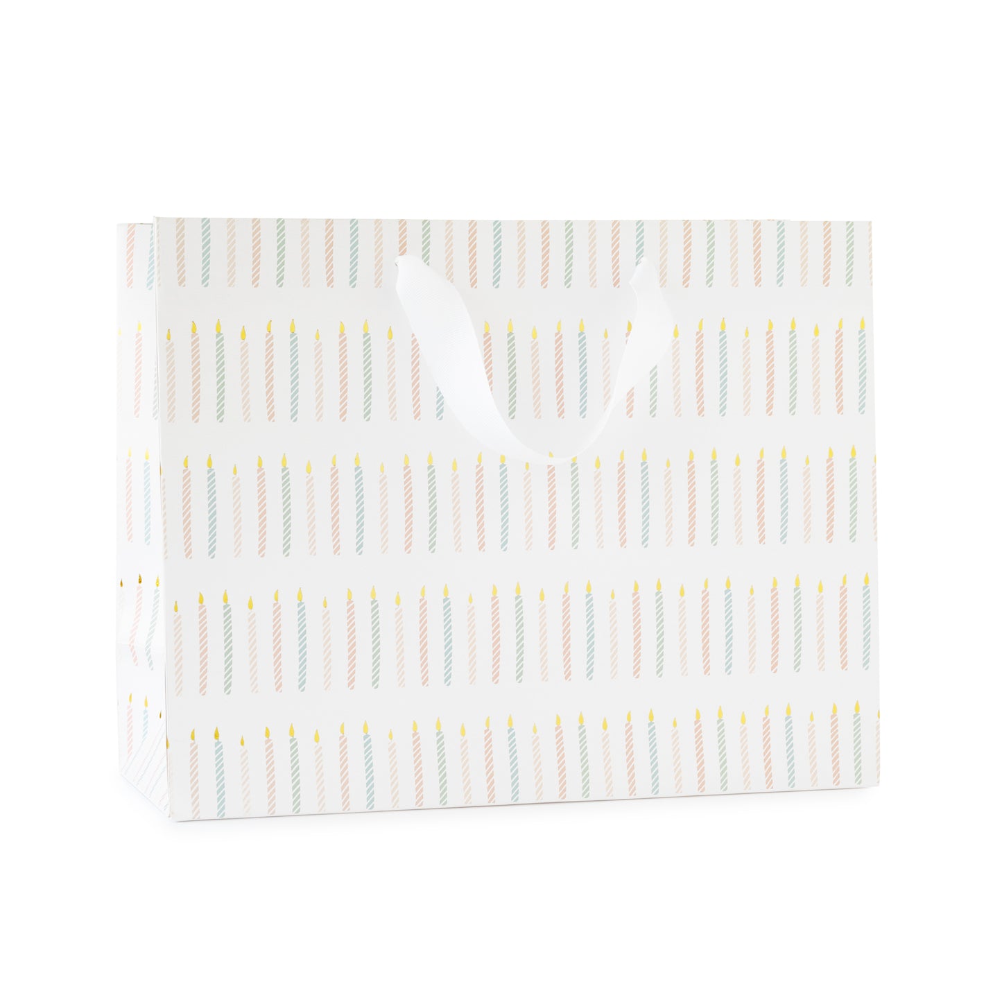 large gift bag with white ribbon handles printed with a colorful candle pattern in pink and blue with gold foil