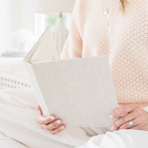 Flax Baby Book open in hands on lap