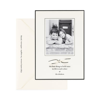 cream and black custom holiday card with ribbon detail and photo