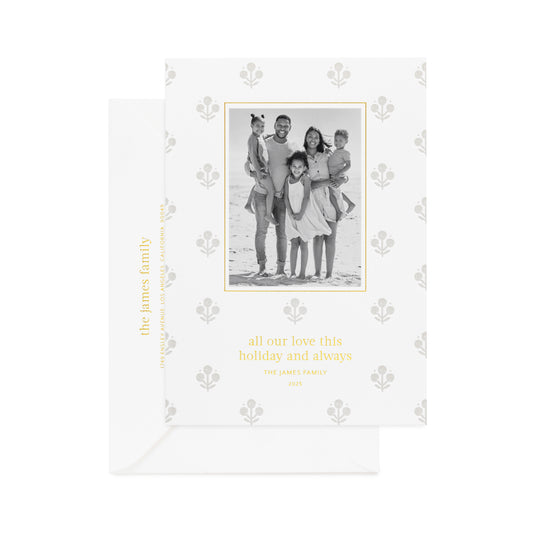 Grey floral pattern on white paper custom holiday card with a family photo in black and white printed in gold foil 'all our love this holiday and always' paired with a white envelope