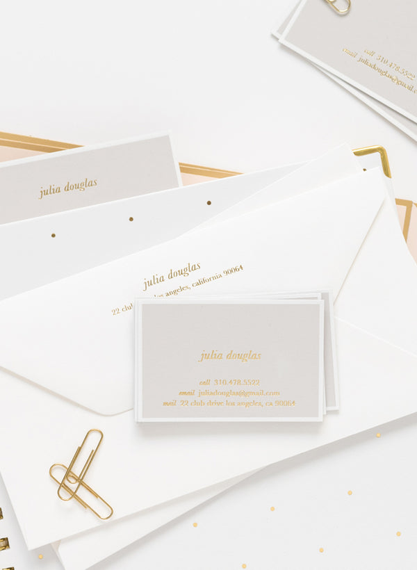 grey calling cards with gold foil paired with white letterhead envelopes with gold foil