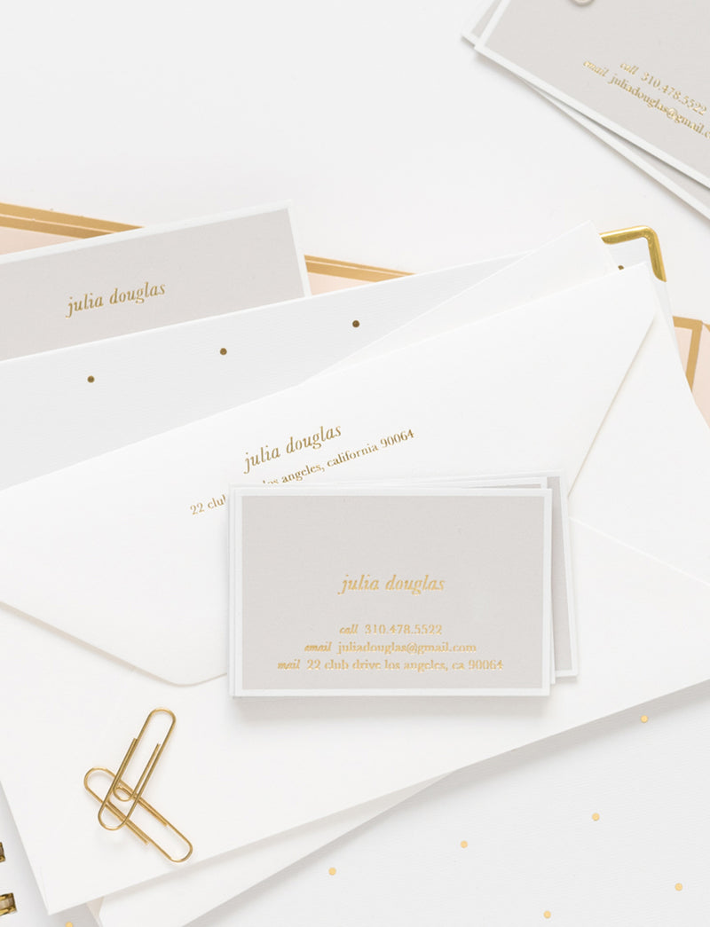 grey calling cards with gold foil paired with white letterhead envelopes with gold foil