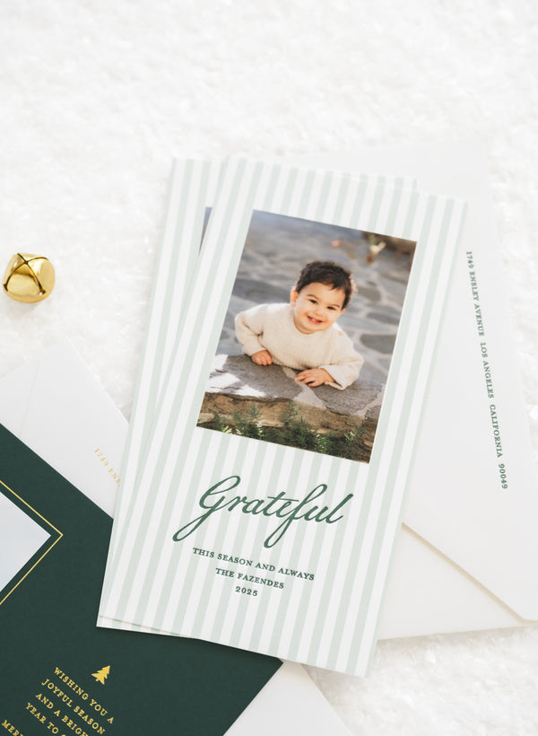 Green striped holiday photo card with photo of a little boy that is printed with green letterpress ink 'Grateful this season and always' the fazendes 2025