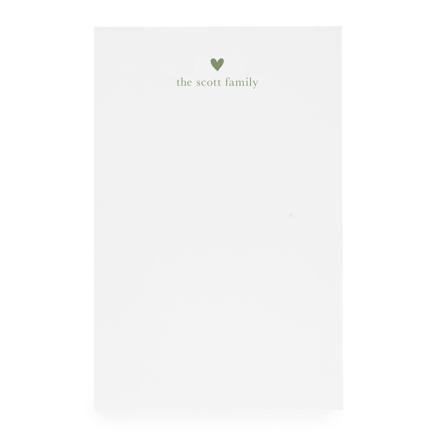 White notepad with heart and "the scott family" printed in moss green