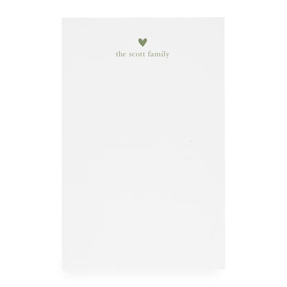 White notepad with heart and "the scott family" printed in moss green