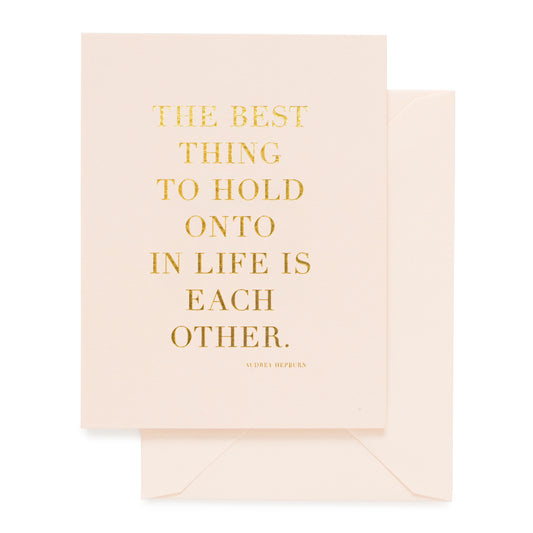 Pale pink card printed in gold foil with "The Best Thing to Hold Onto in life is each other