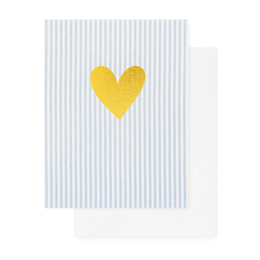 Gold foil heart on blue and white striped paper paired with a white envelope