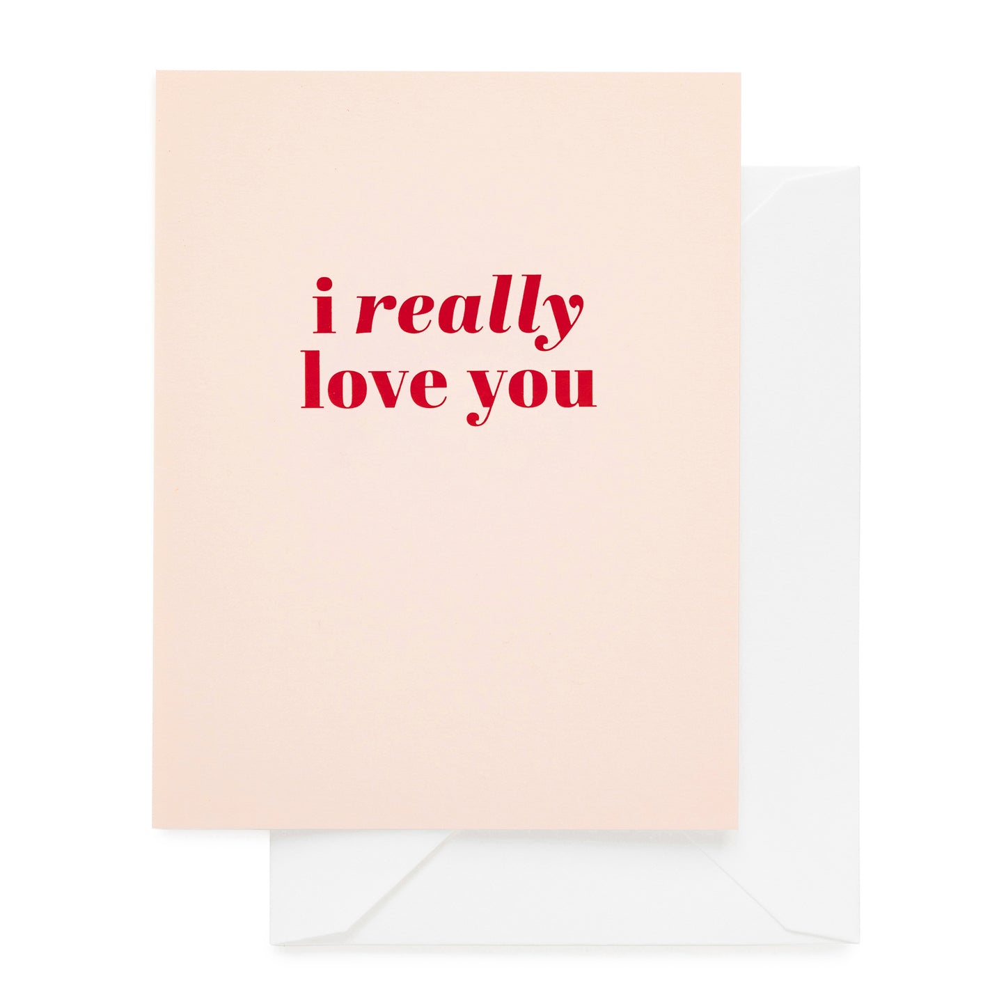 Greeting card with 'i really love you' in red foil text on a light pink card with a white envelope