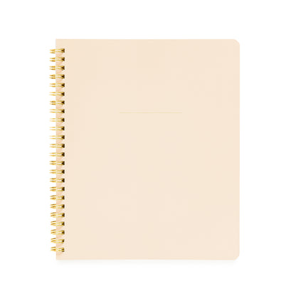Pale pink spiral notebook with gold coil spiral