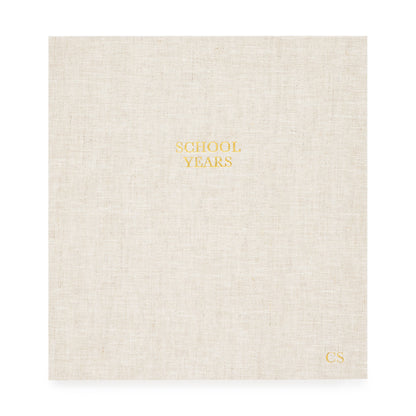 oversized school years book in a flax linen cover foil stamped with school years and kid's initials in gold foil
