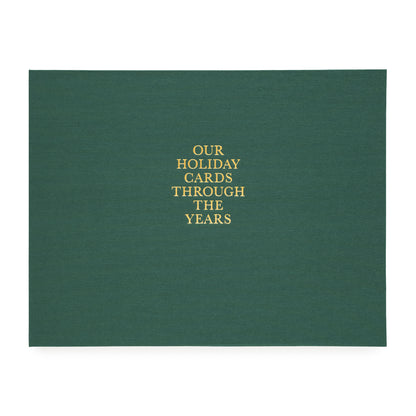 Green fabric album with gold foil printed 'our holiday cards through the years'