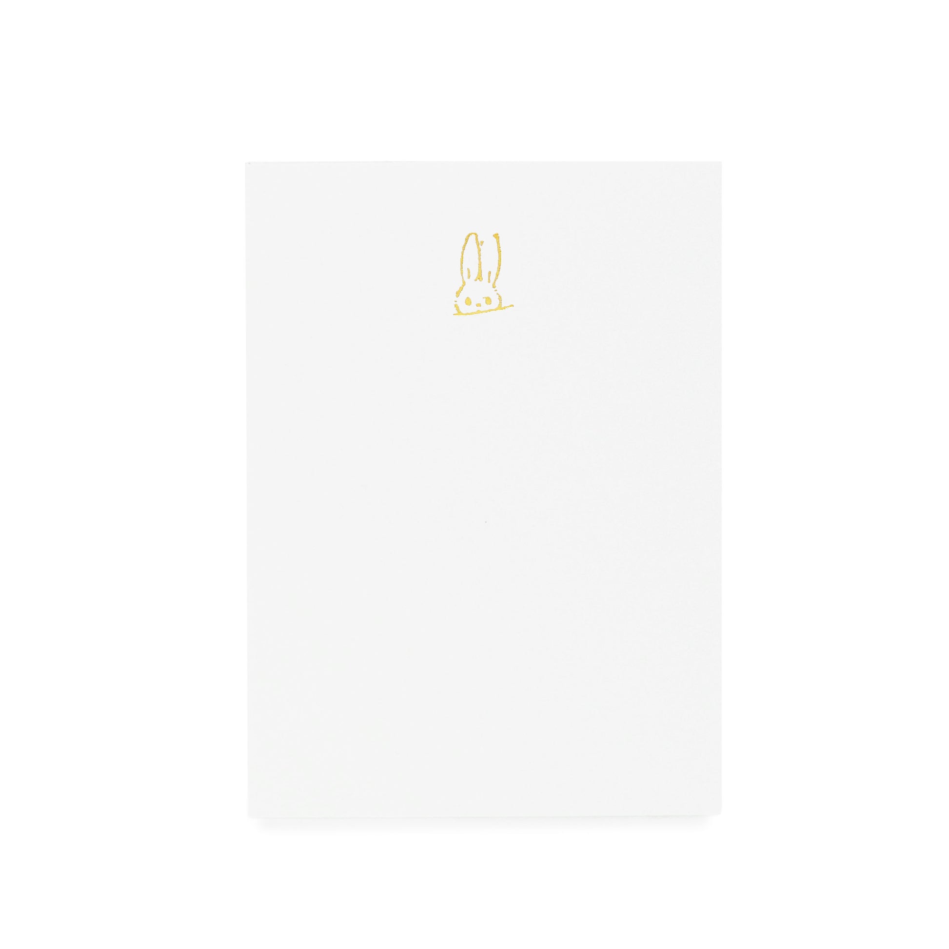 White notepad with gold hand sketched bunny foil printed on it