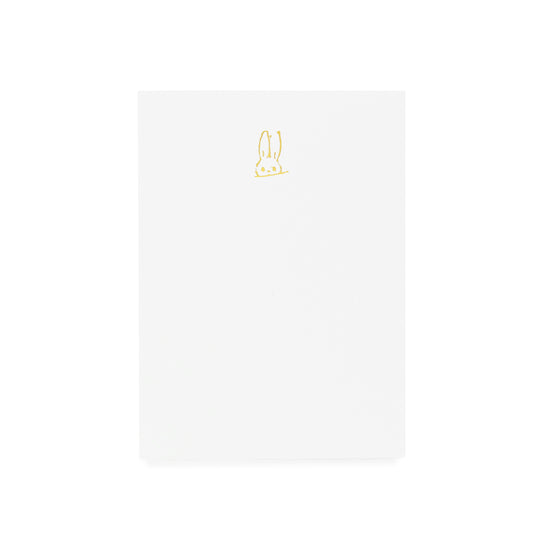 White notepad with gold hand sketched bunny foil printed on it