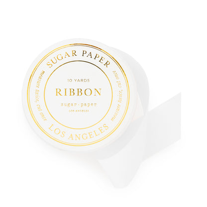 spool of white ribbon with gold foil details