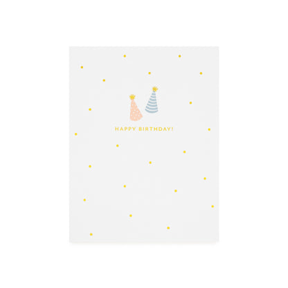White greeting card with birthday hats in gold foil, pale pink, and blue, and 'Happy Birthday!' printed in gold foil