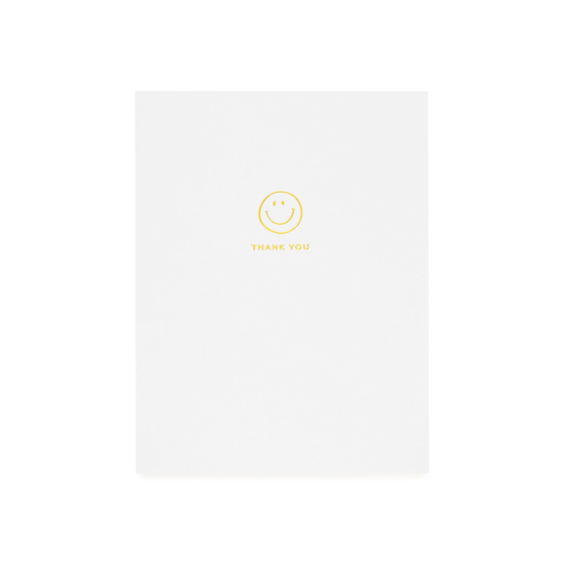 White greeting card printed with gold foil smiley icon and 'thank you'