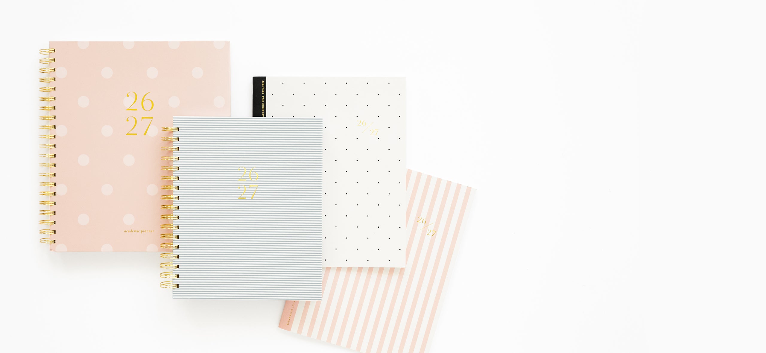 Four planners in different colors on a white background
