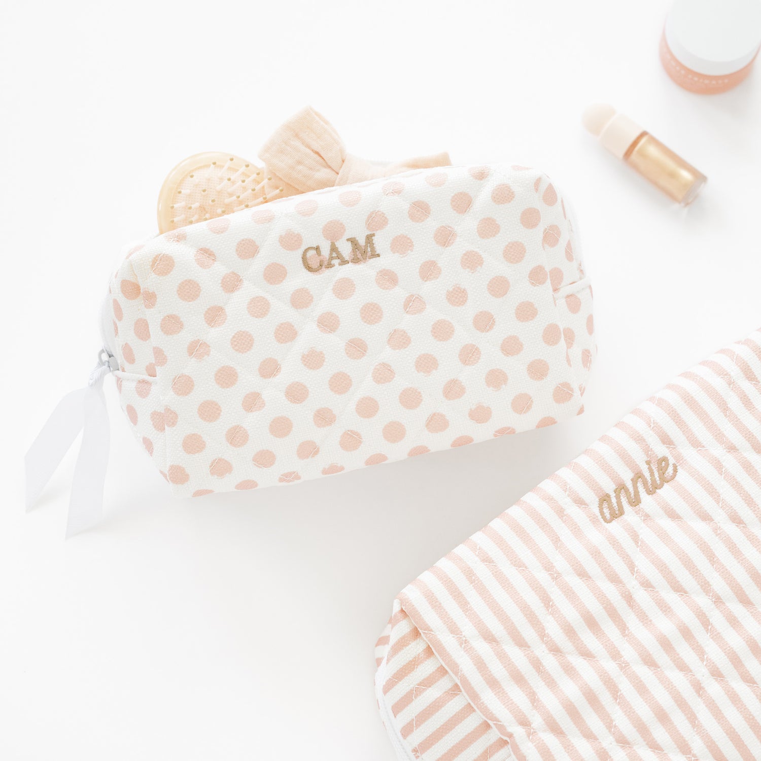 Personalized cosmetic pouches on a white background.