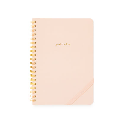 Pink goal tracker spiral notebook with gold spiral binding and a pink elastic band