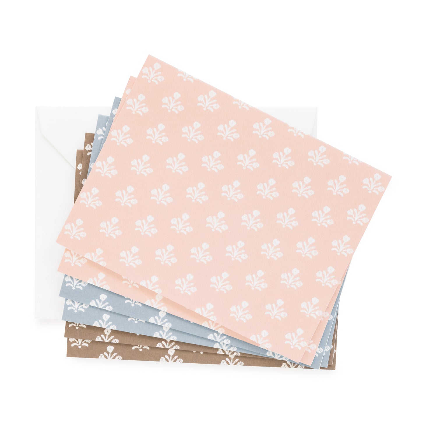 assorted floral notecards in pink, brown, and blue paired with white envelopes