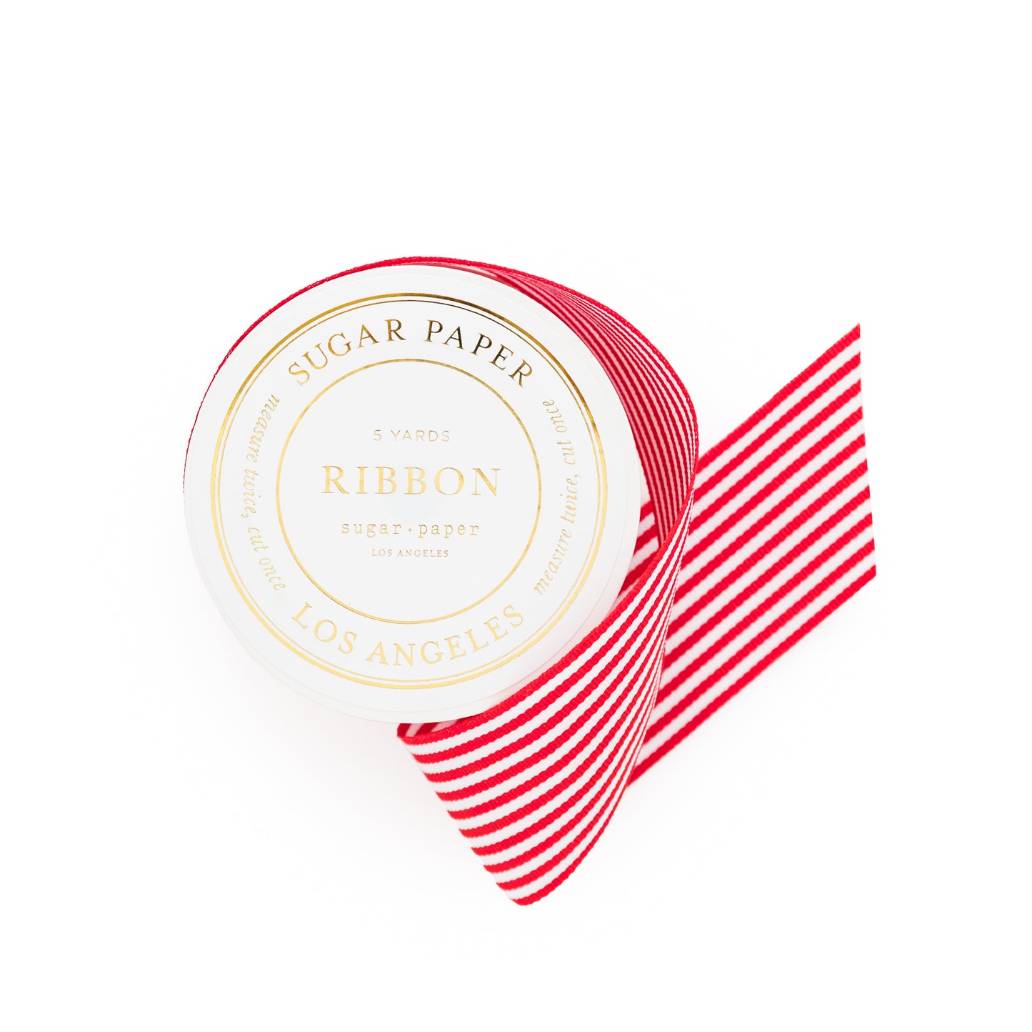 Red and white striped ribbon with 'Sugar Paper' on spool