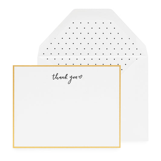 white card with black thank you and heart, gold border, white envelope with black swiss dot liner