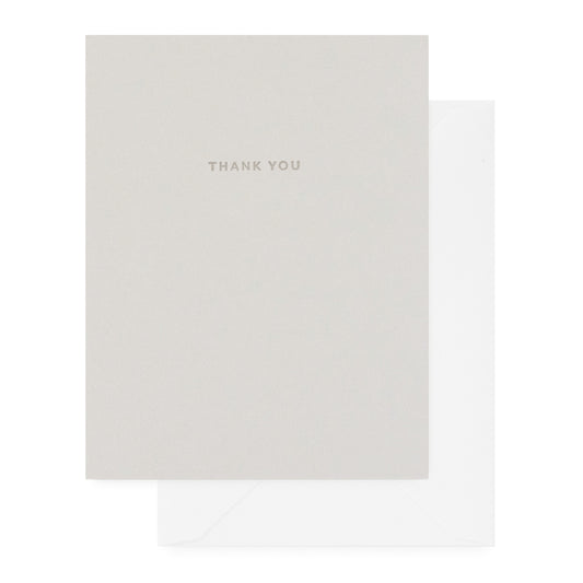 Grey thank you card with dark grey 'thank you' text paired with a white envelope