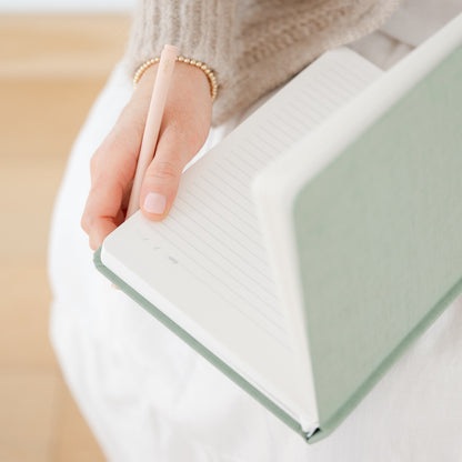 Sage green journal open with interior