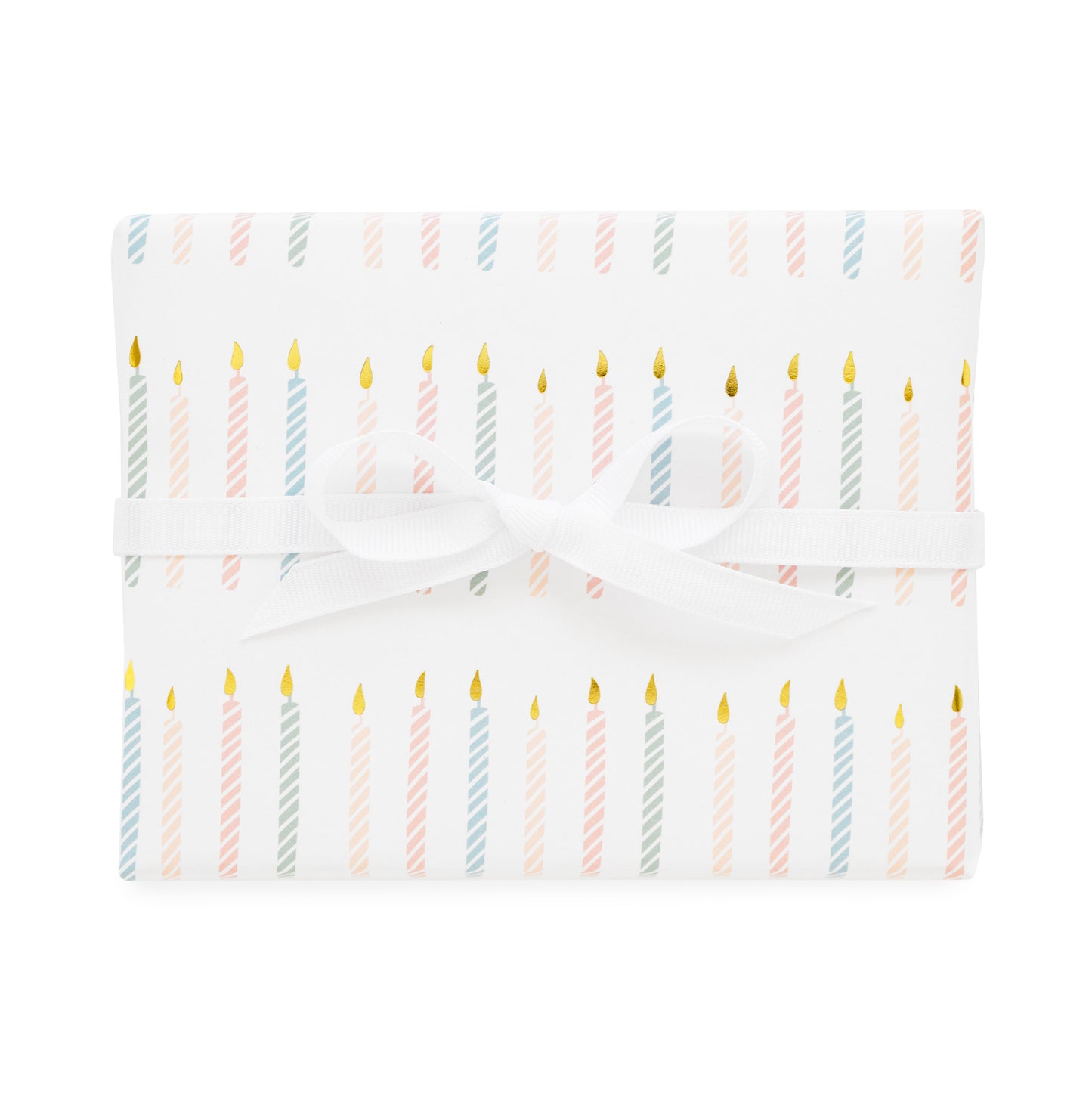 birthday candle gift wrap printed with a colorful candle pattern in pink and blue with gold foil tied with a white ribbon