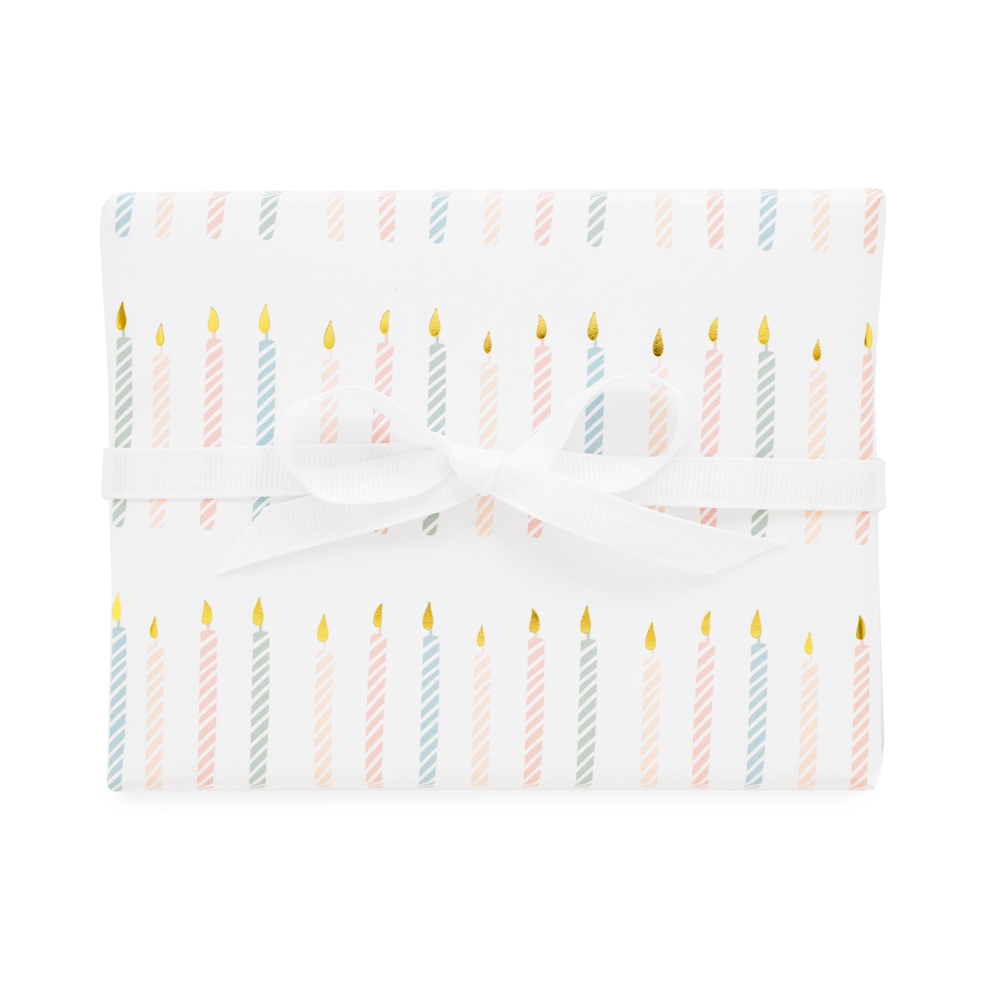 birthday candle gift wrap printed with a colorful candle pattern in pink and blue with gold foil tied with a white ribbon