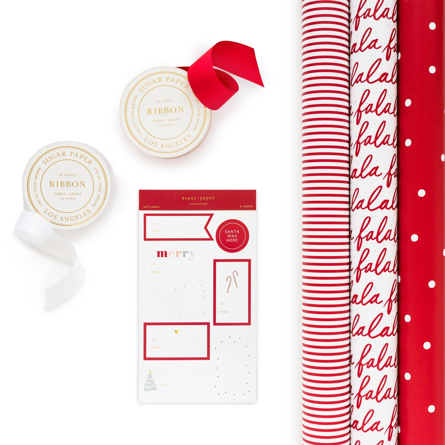 red and white gift wrap trio with christmas gift tag stickers and red and white ribbon spools
