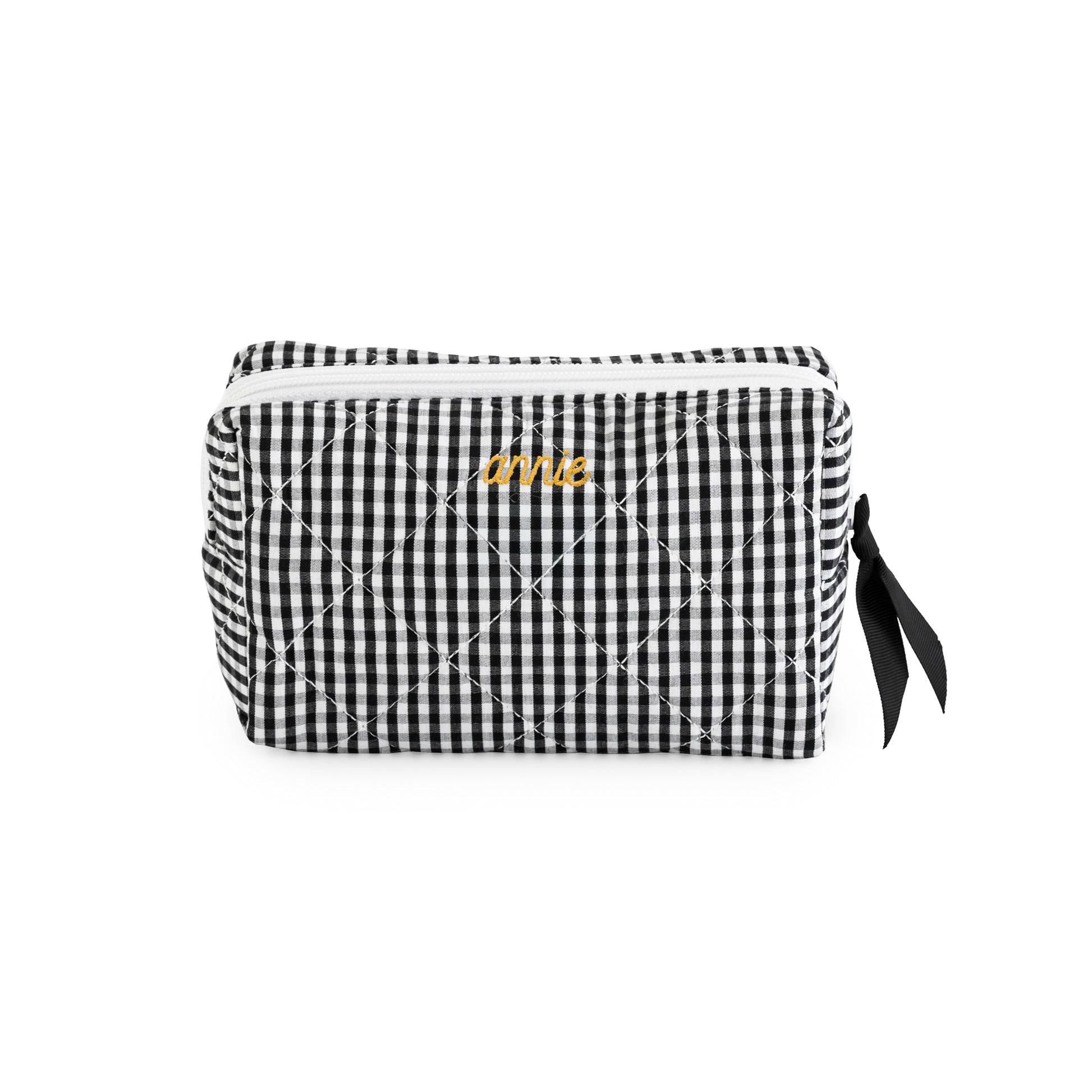 Black and white gingham cosmetic pouch with mustard embroidered name "annie" with a black ribbon pull and white zipper