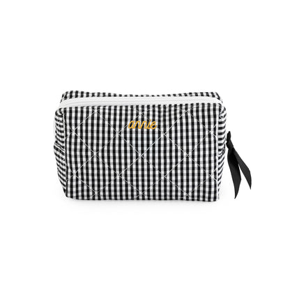 Black and white gingham cosmetic pouch with mustard embroidered name "annie" with a black ribbon pull and white zipper