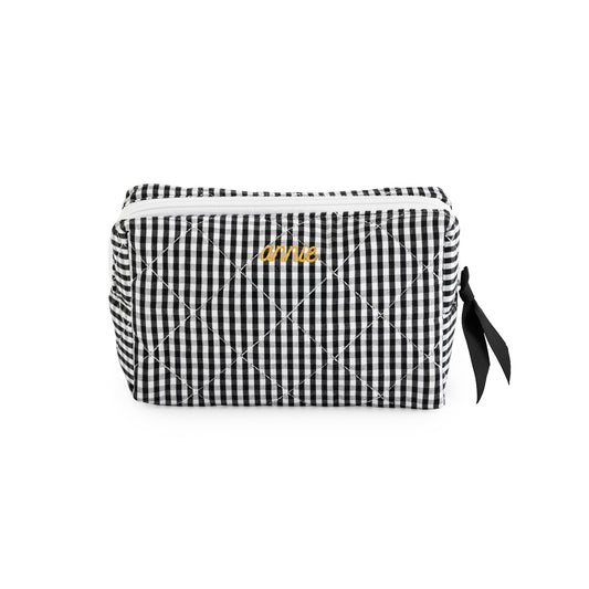 Black and white gingham cosmetic pouch with mustard embroidered name "annie" with a black ribbon pull and white zipper