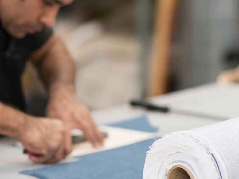 Man cutting Sugar Paper fabric to be used in products
