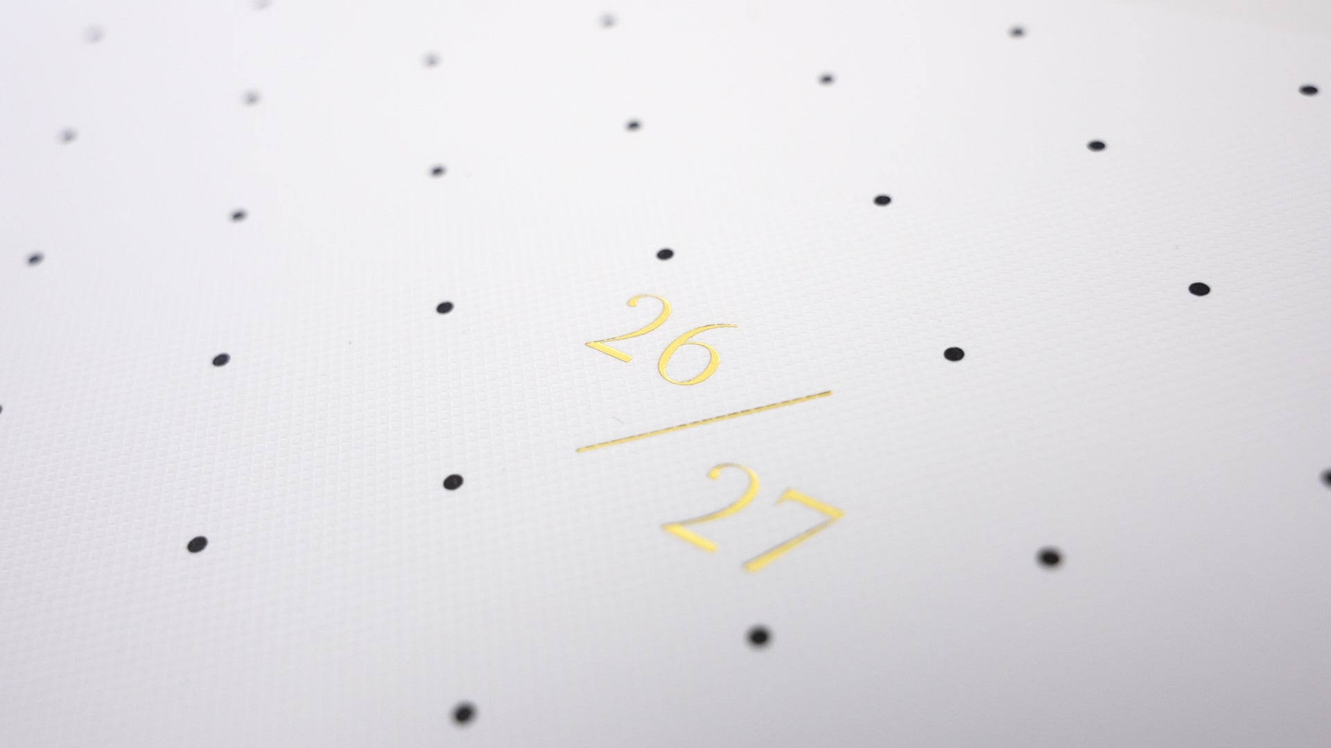 Load video: Monthly planner with black dot pattern with gold foil '26 / 27' dates on cover
