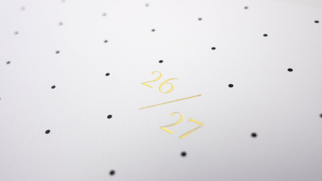 Monthly planner with black dot pattern with gold foil '26 / 27' dates on cover