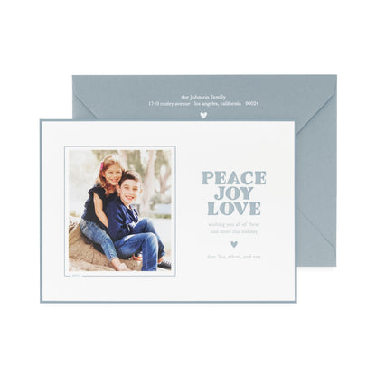 white card with photo and slate blue text, slate blue envelope with white text