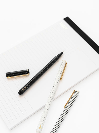 black and white felt pens on note pad