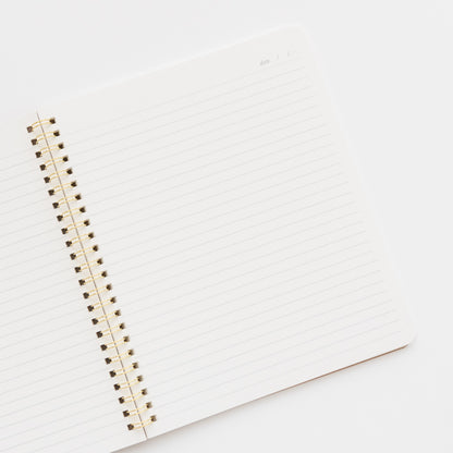 open spiral notebook showing lined pages