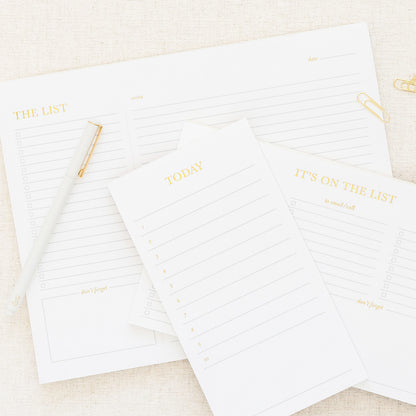 stacked list pads with white felt pen