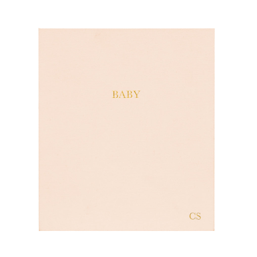 This is the cover of our baby book in a pale pink color for a baby girl. #color_pale-pink